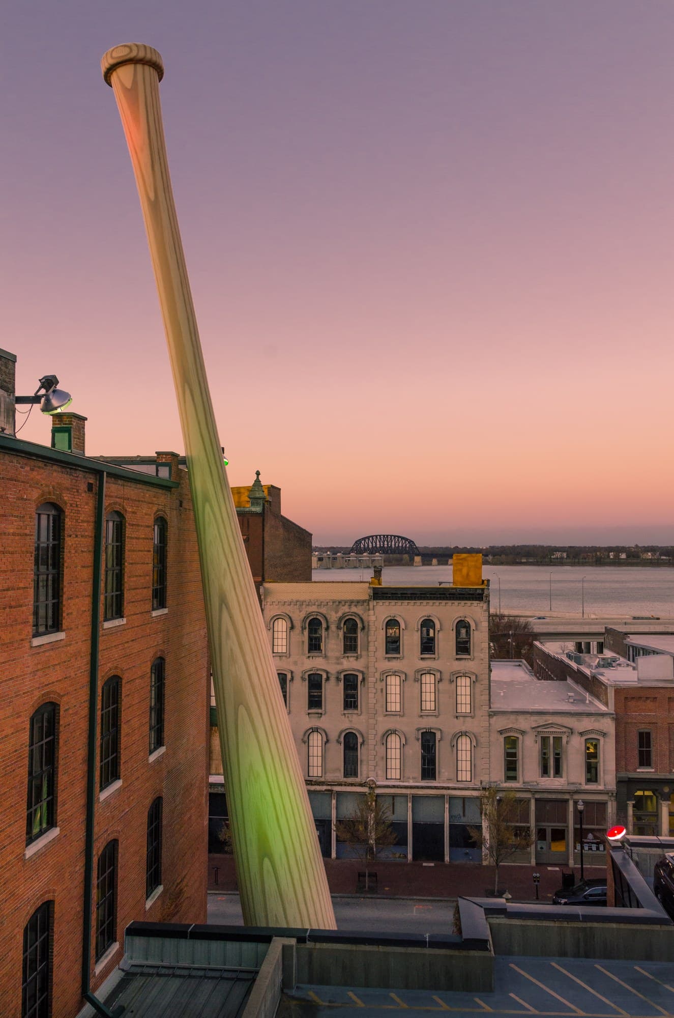 The Louisville Slugger Big Bat silhouetted above Museum Row at sunset