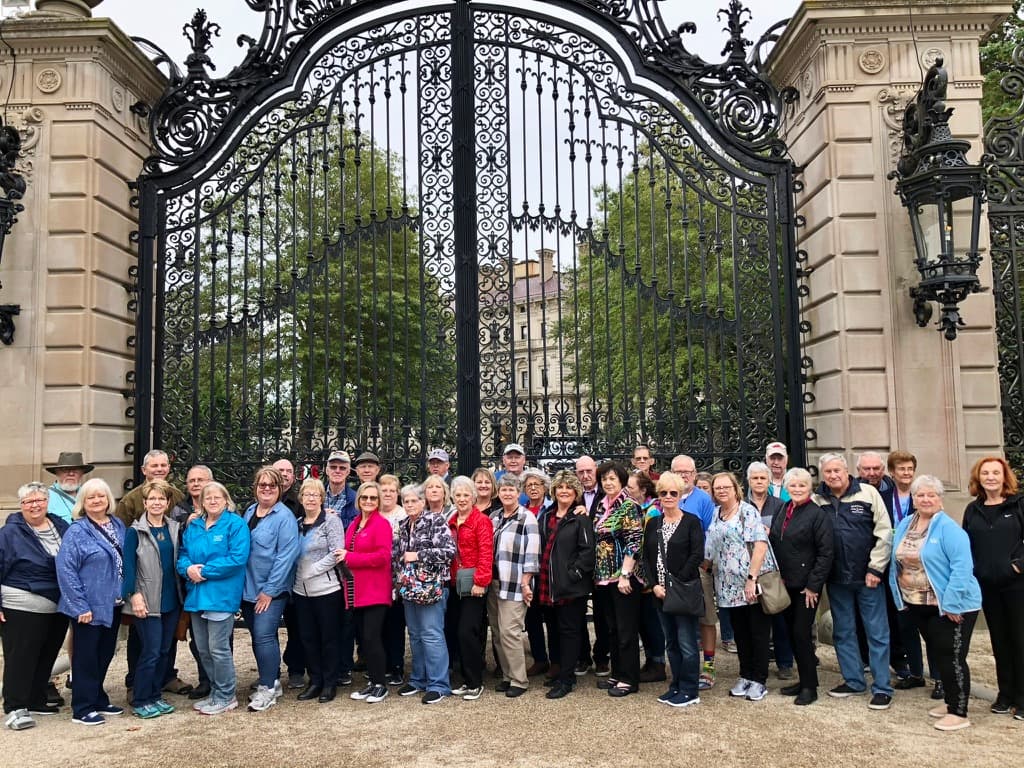A Great Falls Travel group together outside a Newport mansion