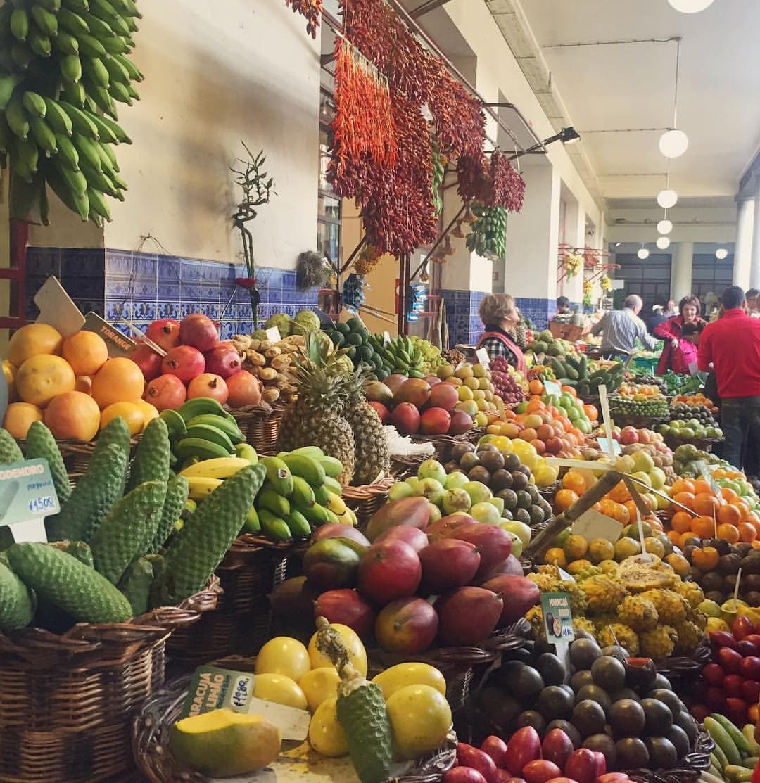Colorful tropical fruit stalls inside Mercado dos Lavradores in Funchal