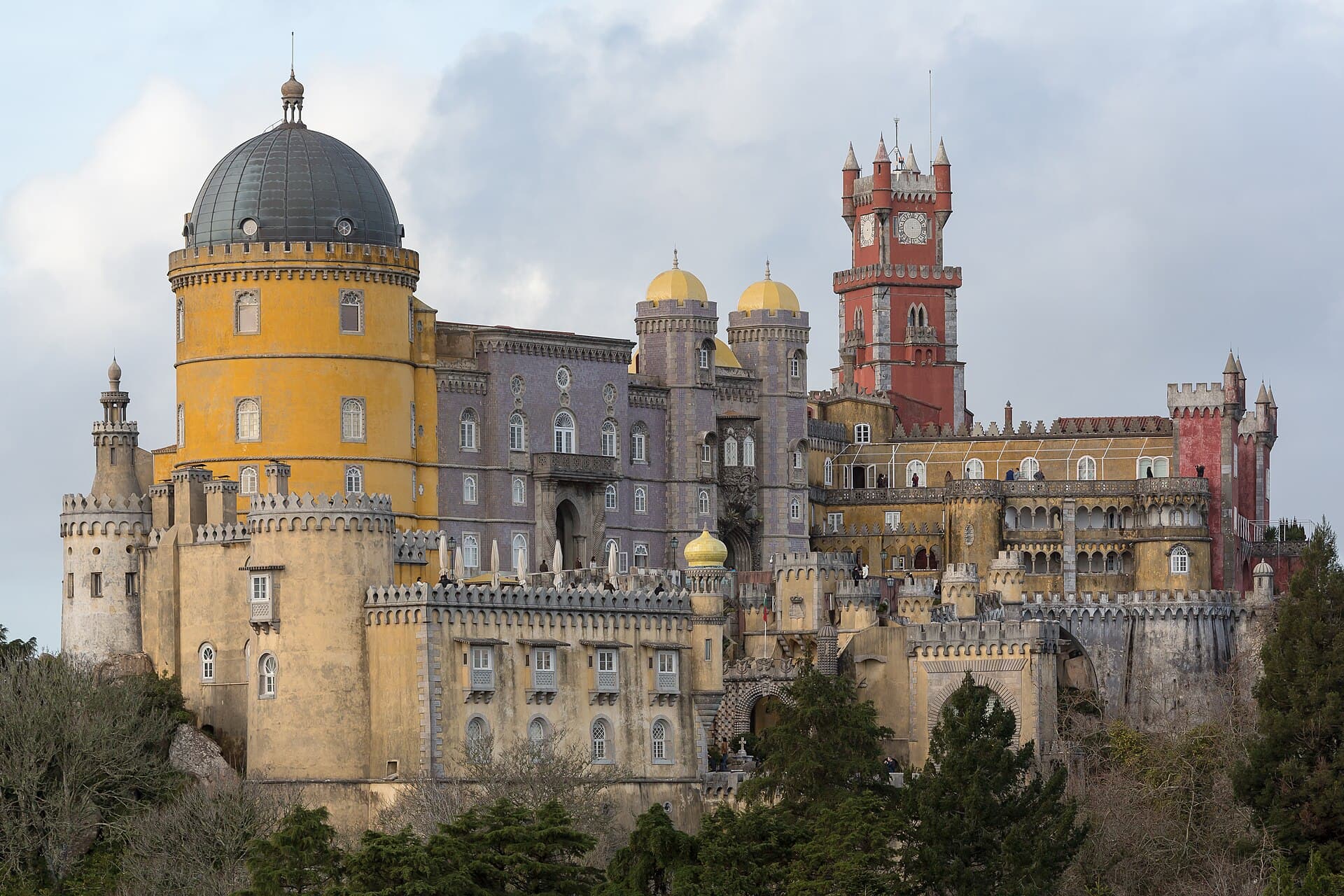 Colorful domes and towers of Pena Palace above the Sintra hills