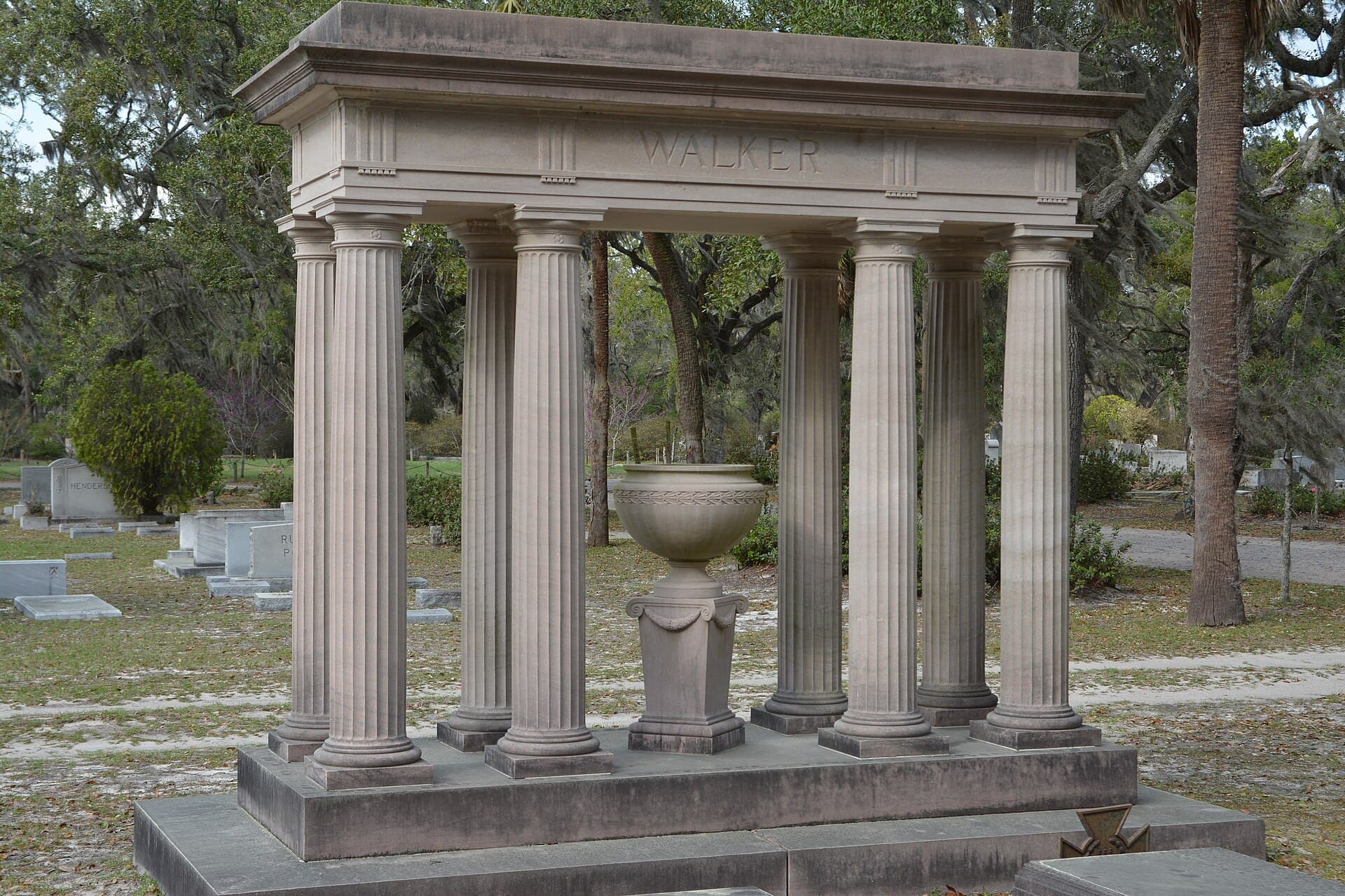 Columned monument beneath moss-draped oaks at Bonaventure Cemetery