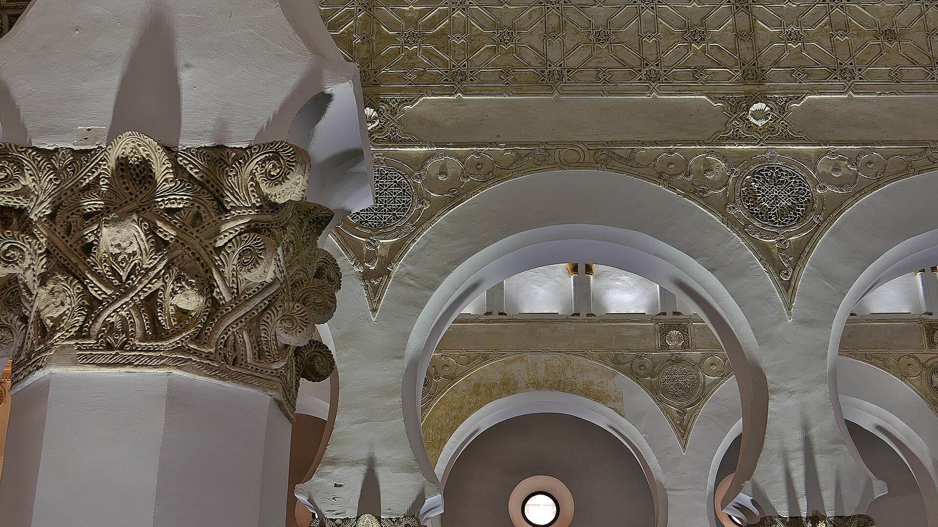 White horseshoe arches inside the Synagogue of Santa María la Blanca in Toledo